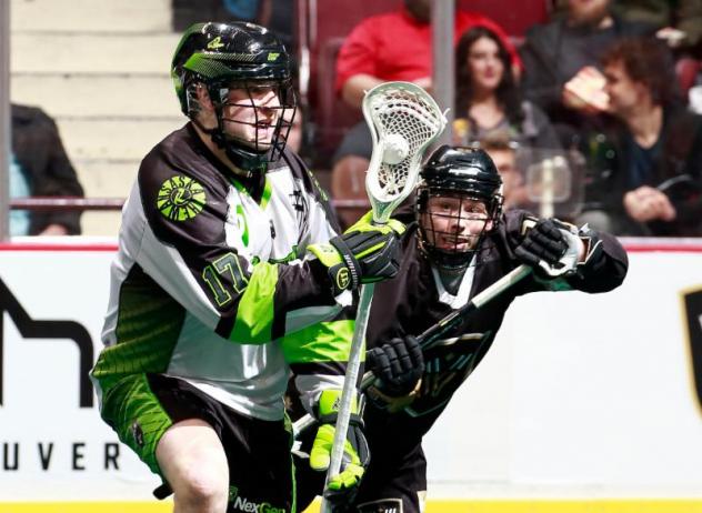 Saskatchewan Rush forward Robert Church (left) battles the Vancouver Warriors