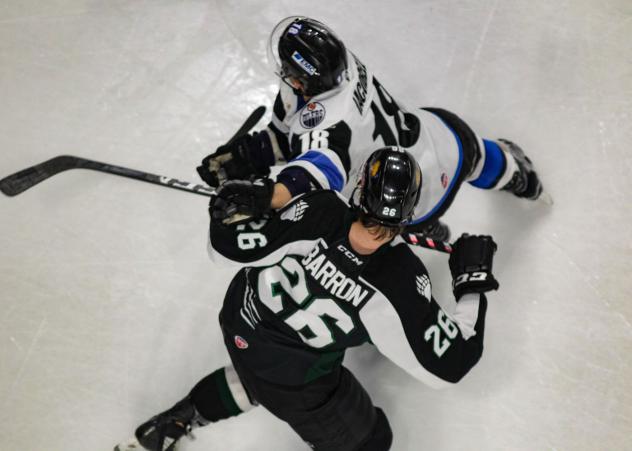 Utah Grizzlies forward Travis Barron tangles with the Wichita Thunder