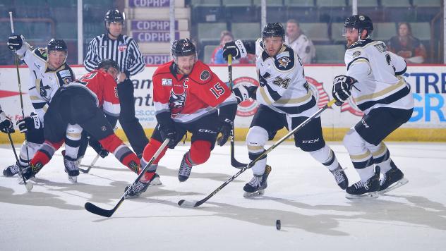 James Henry of the Adirondack Thunder (15) eyes a loose puck against the Wheeling Nailers