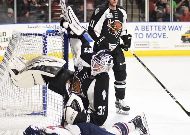 Utah Grizzlies goaltender Kevin Carr gets bowled over against the Tulsa Oilers