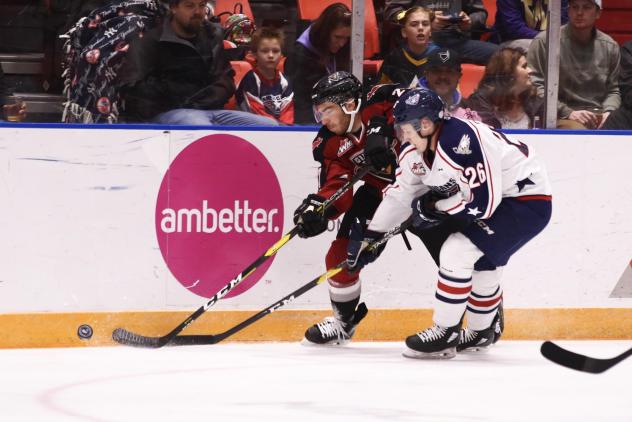 Vancouver Giants defenceman Seth Bafaro (left) against the boards vs. the Tri-City Americans