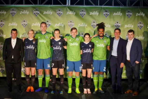 Sounders FC and Reign FC players wear their new Zulily-branded kits alongside team and Zulily leadership