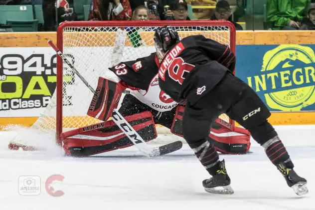 Justin Almeida of the the Moose Jaw Warriors shoots against the Prince George Cougars