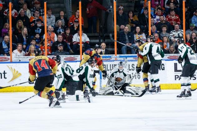Utah Grizzlies goaltender Kevin Carr attempts to hold off the Kansas City Mavericks