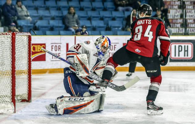 Vancouver Giants left wing Brayden Watts and the Kamloops Blazers goaltender