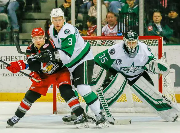 Texas Stars goaltender Landon Bow and defenseman Dillon Heatherington try to keep the Grand Rapids Griffins at bay