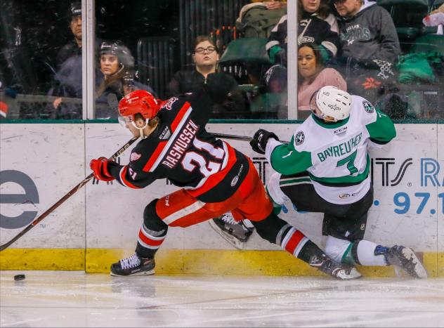 Michael Rasmussen of the Grand Rapids Griffins squeezes past the Texas Stars
