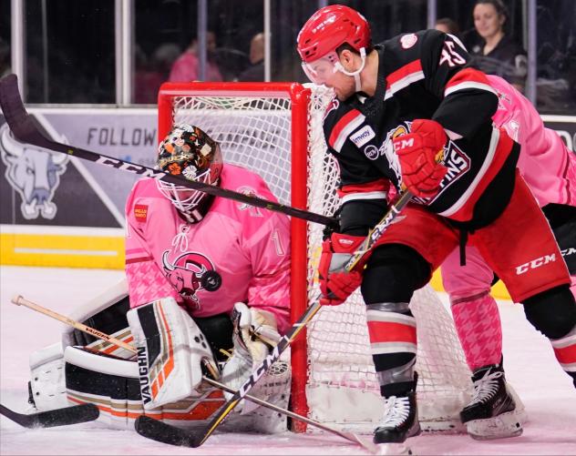 Grand Rapids Griffins right wing Colin Campbell tries to squeeze the puck past San Antonio Rampage goaltender Jared Coreau