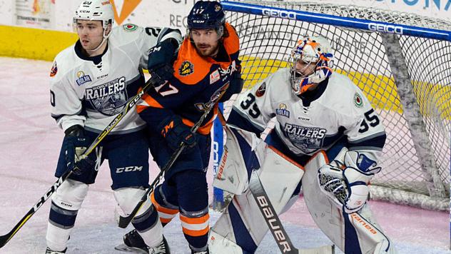 Greenville Swamp Rabbits forward Austen Brassard sandwiched by the Worcester Railers