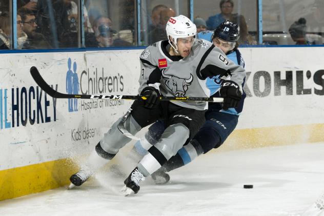 Mitch Reinke of the San Antonio Rampage fights off a check from Milwaukee Admiral Justin Kirkland