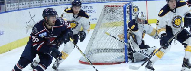 South Carolina Stingrays forward Christian Horn (left) skates around the Norfolk Admirals net