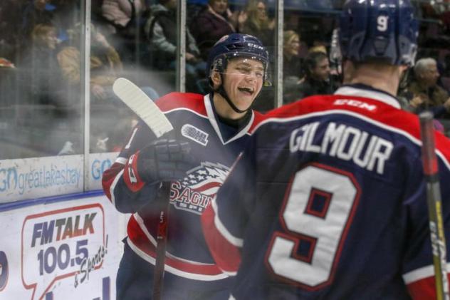 Saginaw Spirit exchange congratulations after a goal against the Owen Sound Attack