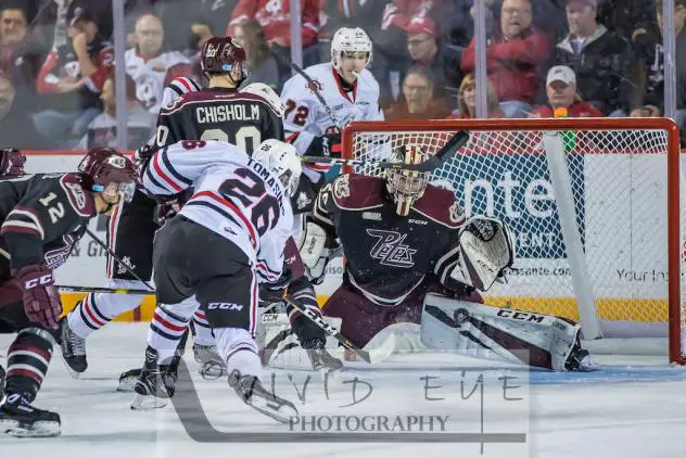 Philip Tomasino of the Niagara IceDogs takes a shot against the Peterborough Petes