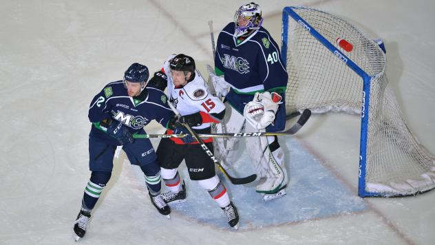 Adirondack Thunder forward James Henry (center) battles the Maine Mariners