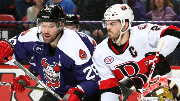 Binghamton Devils left wing Eric Tangradi (left) against the Belleville Senators