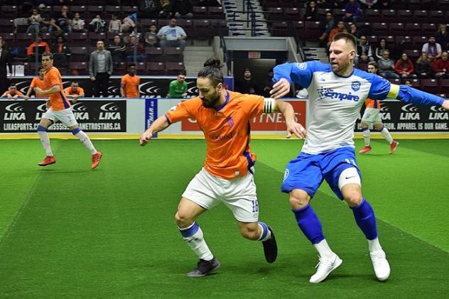 Mississauga MetroStars' Mo Babouli (left) and Utica City FC captain Bo Jelovac fight for possession of the ball