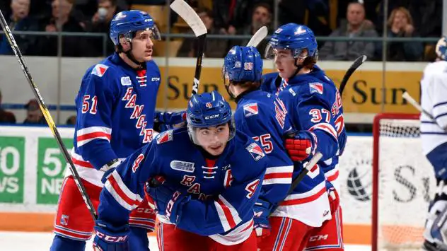 Kitchener Rangers exchange congratulations after scoring against the Mississauga Steelheads