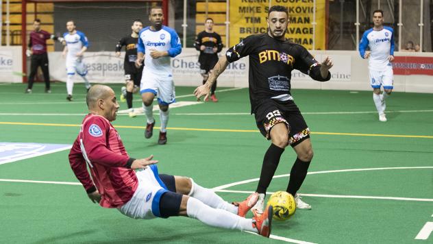Juan Pereira of the Baltimore Blast (right) fights through a Utica City tackle attempt