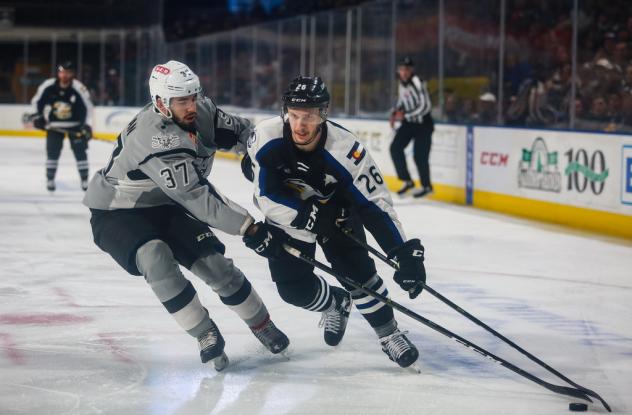 Jake Walman of the San Antonio Rampage (left) defends Colorado Eagles forward Andrew Agozzino