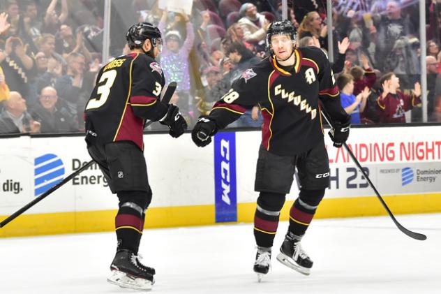 Tommy Cross and Zac Dalpe of the Cleveland Monsters exchange congratulations