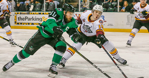 Texas Stars center Justin Dowling (left) takes on the Chicago Wolves