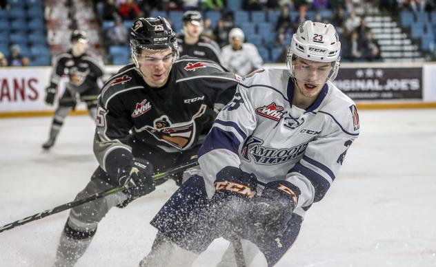 Vancouver Giants defenceman Kaleb Bulych (left) vs. the Kamloops Blazers