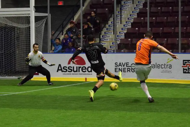 Jon Orlando of the Baltimore Blast (right) shoots vs. the Mississauga Metrostars