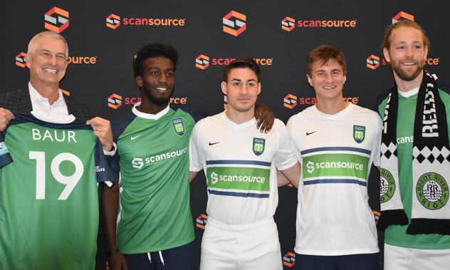 Scansource CEO Mike Bauer (left) and Greenville Triumph Chief Brand Officer Doug Erwin (right) with players