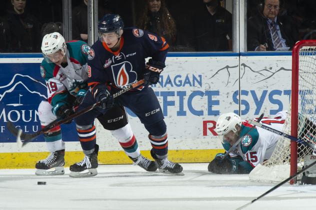 Kelowna Rockets centre Ethan Ernst (left) battles the Kamloops Blazers
