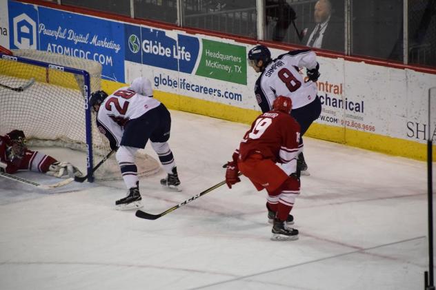 Braylon Shmyr of the Allen Americans (right in red) tries to help out this goaltender