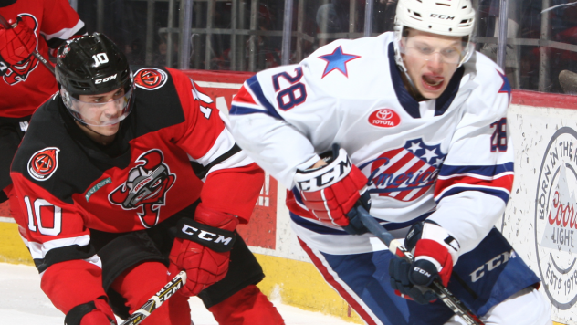 Binghamton Devils center Ryan Schmelzer (left) against the Rochester Americans