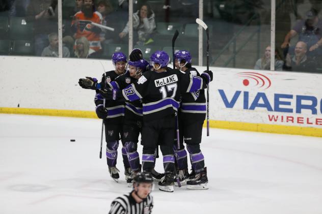 Tri-City Storm huddle in celebration after a goal