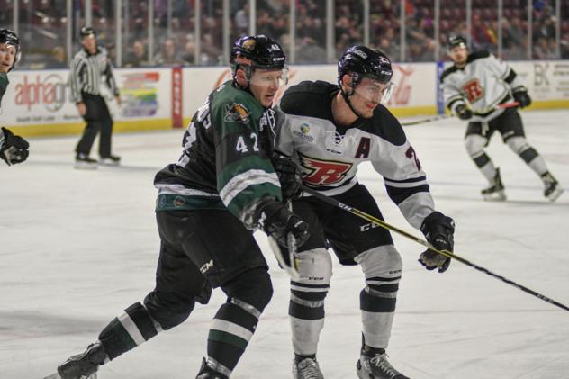 Utah Grizzlies forward Mike Economos (left) vs. the Rapid City Rush