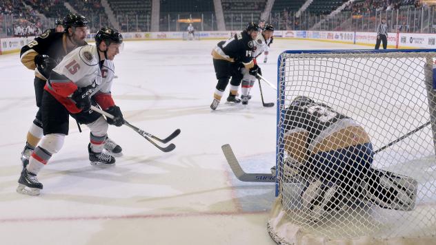 James Henry of the Adirondack Thunder (left) eyes the Newfoundland Growlers goal