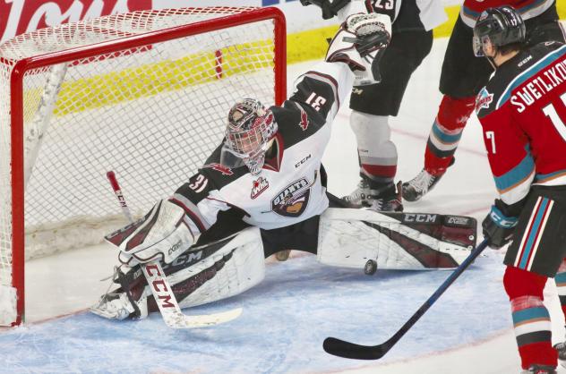 Vancouver Giants goaltender Trent Miner stretches to make a stop against the Kelowna Rockets