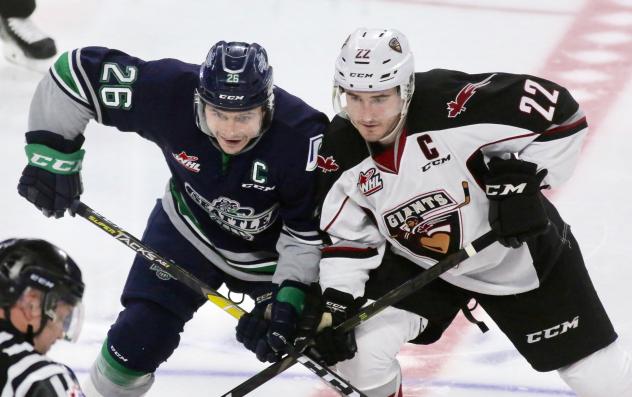 Vancouver Giants right wing Jared Dmytriw (right) faces off with the Seattle Thunderbirds