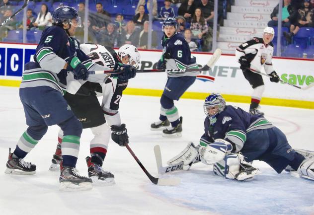 Jadon Joseph of the Vancouver Giants (center) tries to get off a shot against the Seattle Thunderbirds