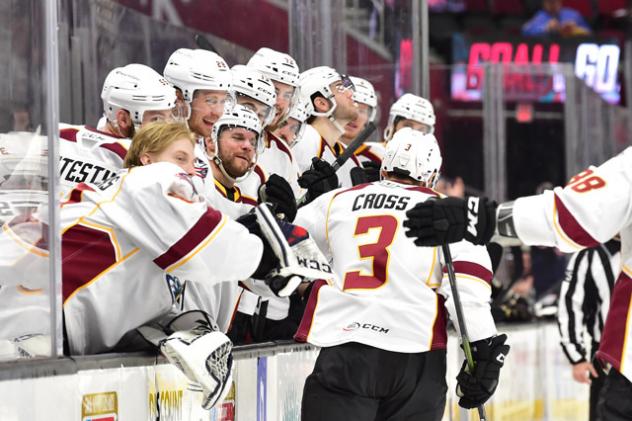 Tommy Cross receives congratulations from the Cleveland Monsters bench