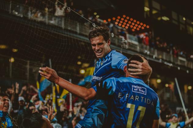Salgado and Edson Partido celebrate the first win for El Paso Locomotive FC