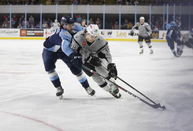 Charlie Sampair of the San Antonio Rampage (right) fights for ice against Milwaukee Admirals forward Justin Kirkland