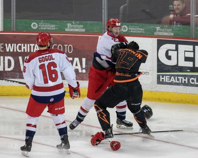 Josh Atkinson of the Allen Americans (white) fights with the Wichita Thunder
