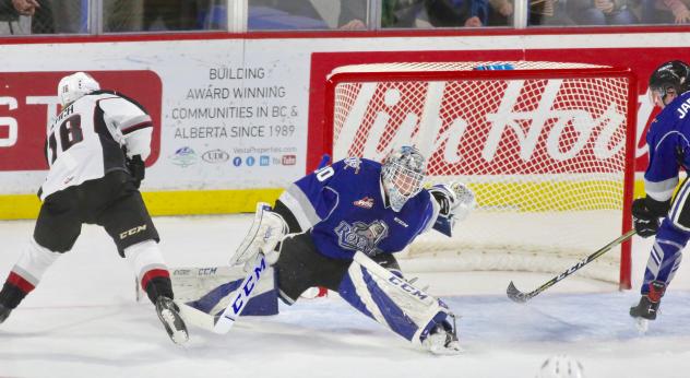 Davis Koch of the Vancouver Giants (left) scores against the Victoria Royals