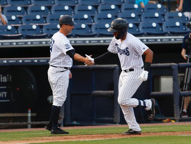 Kevin Mahoney (left) congratulates Dermis Garcia of the Tampa Tarpons after Garcia's homer
