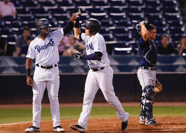 Steven Sensley and Donny Sands exchange high fives for the Tampa Tarpons