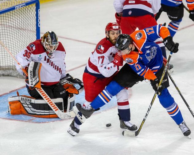 Allen Americans goaltender Lukas Hafner and forward Duggie Lagrone attempt to keep the Tulsa Oilers at bay