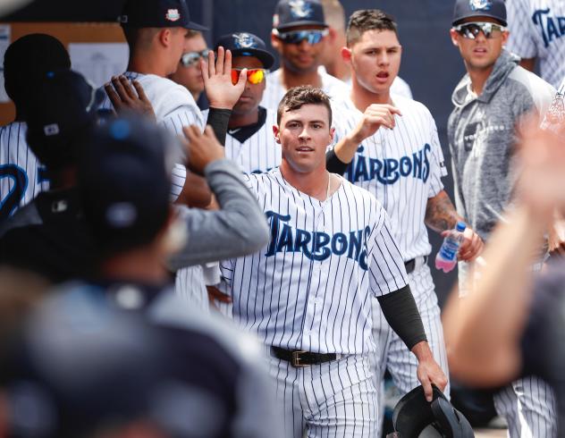 Matt Pita of the Tampa Tarpons receives congratulations in the dugout