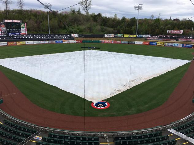 The tarp over the field at Smokies Stadium