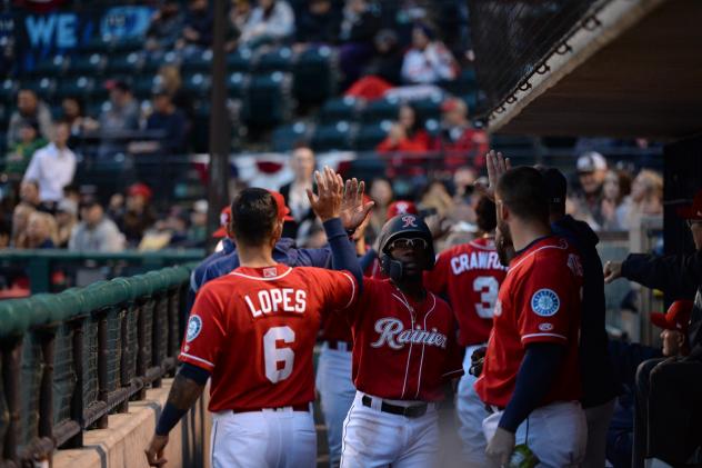 Shed Long gets high fives in the Tacoma Rainiers dugout
