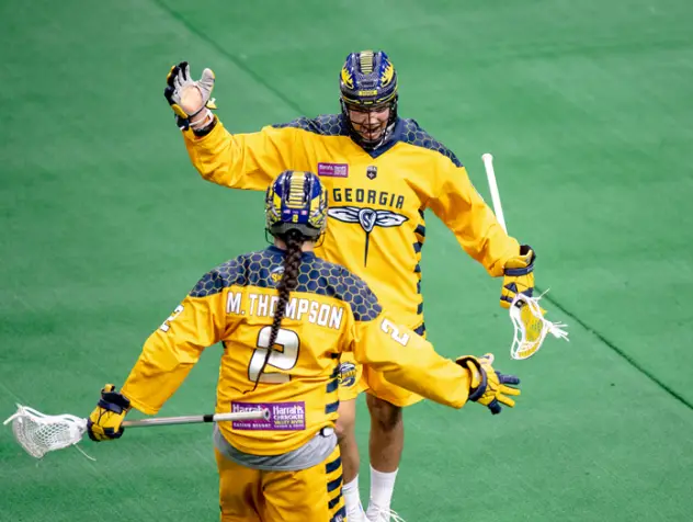 Georgia Swarm exchange high fives after a goal