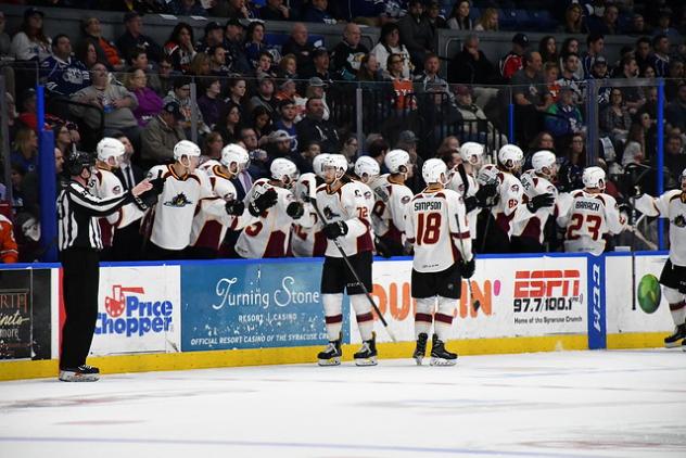 Cleveland Monsters exchange congratulations with the bench following a score